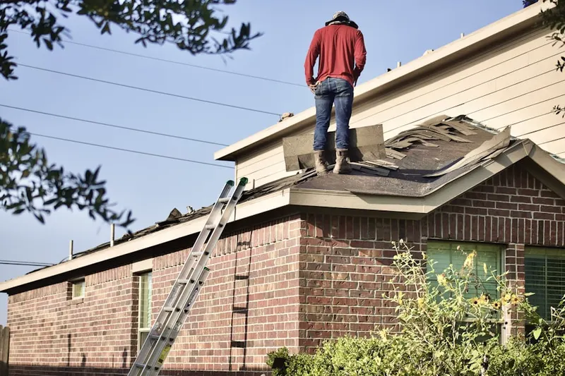 Professional roofer working on a residential roof in Farmingville